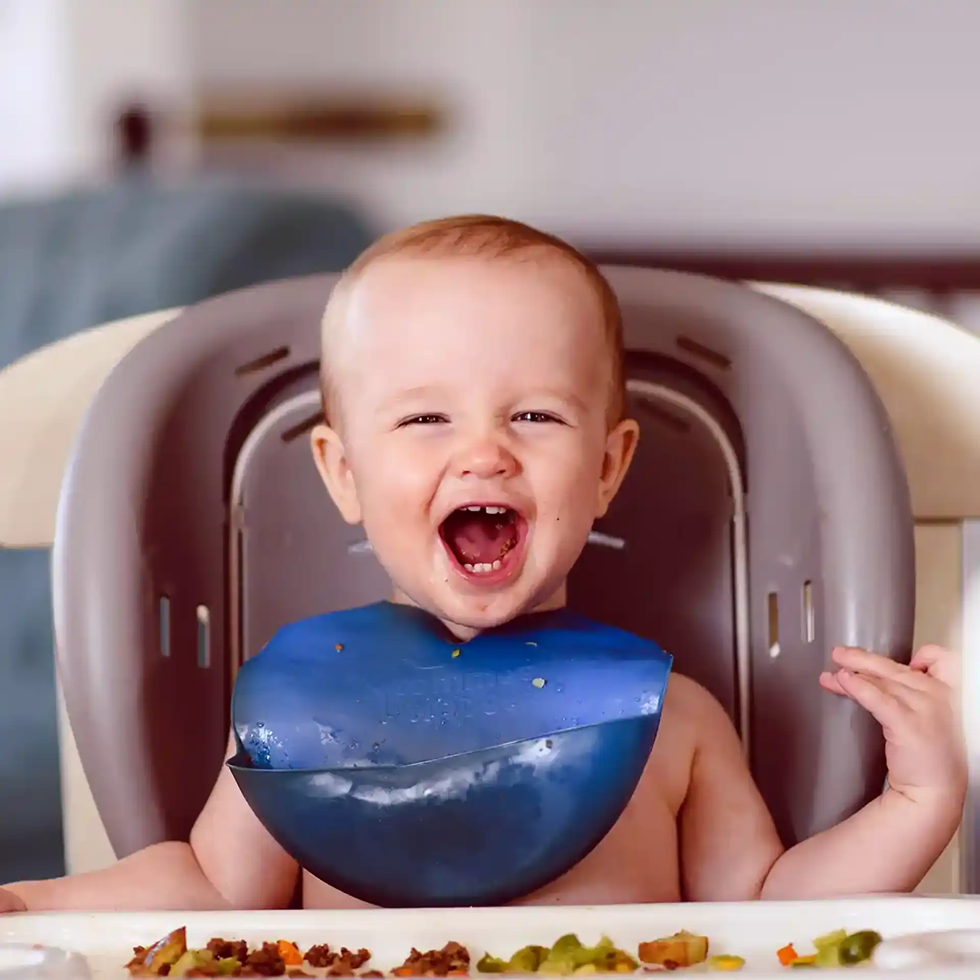 Baby in chair smiling