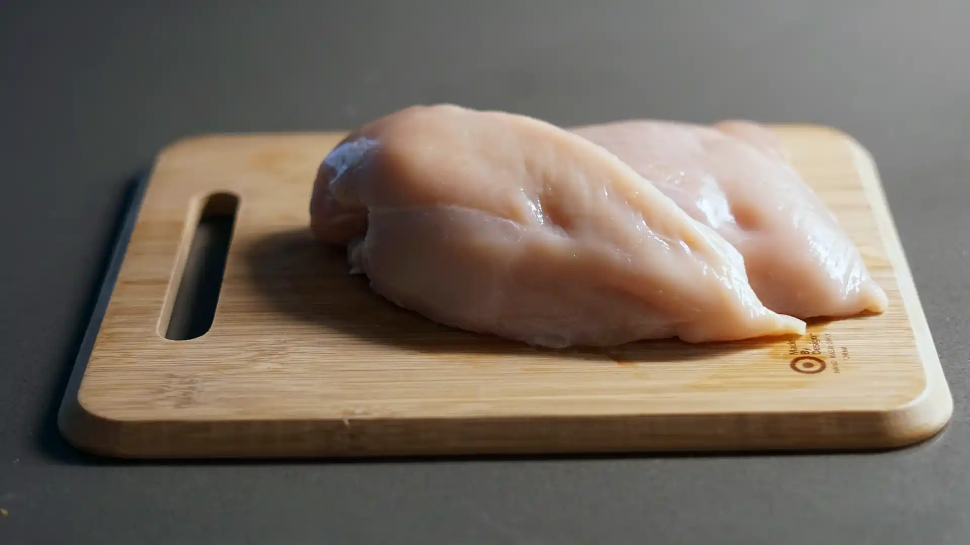 Chicken breasts on top of a cutting board